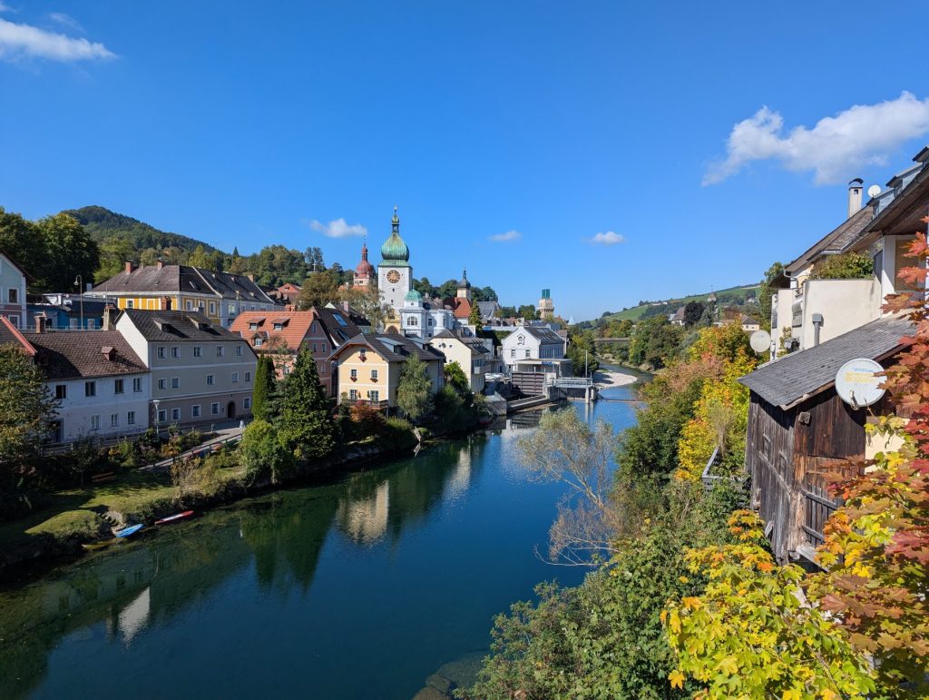 View of the river Ybbs surrounding by charming houses and fall greenery.