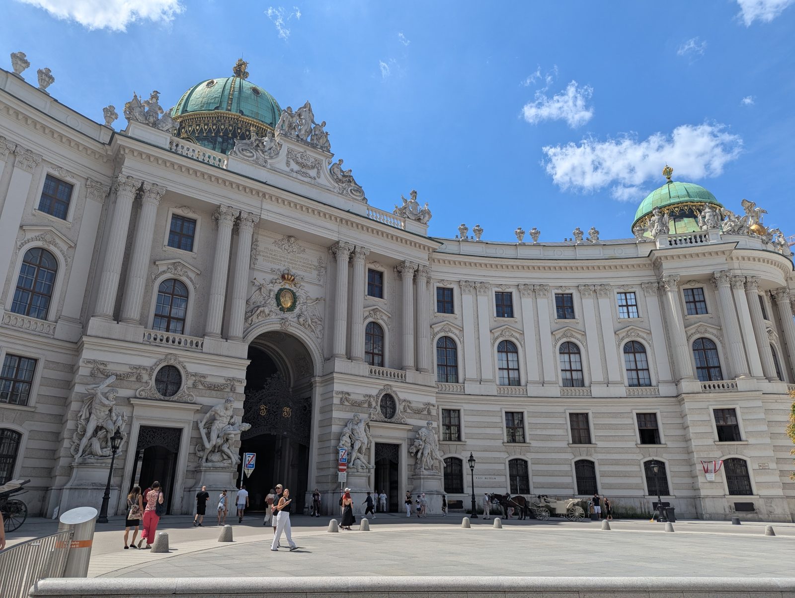 Entrance courtyard of Hofburg Palace in Vienna under a clear blue sky