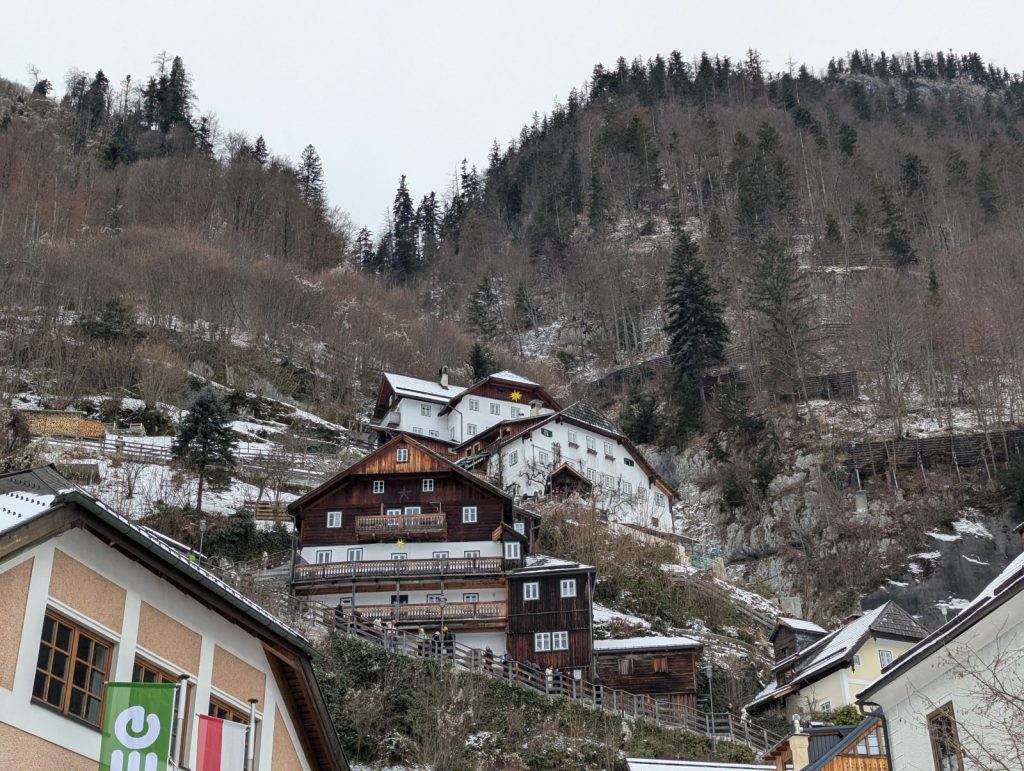 Charming hillside houses in Hallstatt surrounded by Austrian alpine mountains